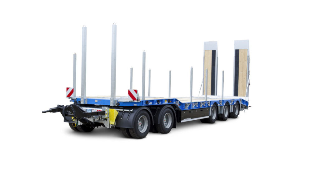 Heavy-duty low-loader flatbed trailer with multiple axles, removable stakes, drawbar and hydraulic ramps—ideal for transporting construction machinery and long loads.