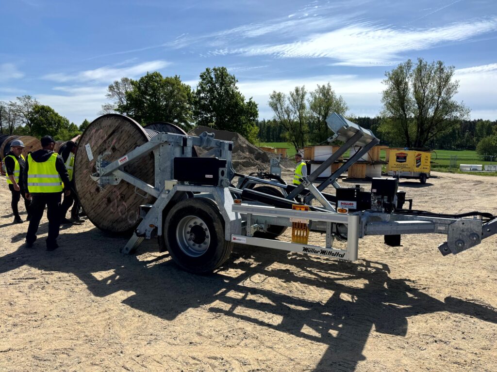 Hydraulically lowerable cable drum trailer—galvanized chassis with reel cradle and drawbar, ideal for cable laying in utility and fiber-optic projects.